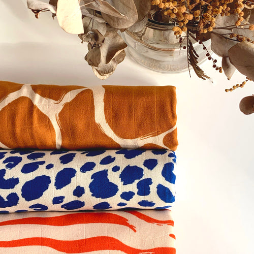 Custom printed muslin swaddles folded