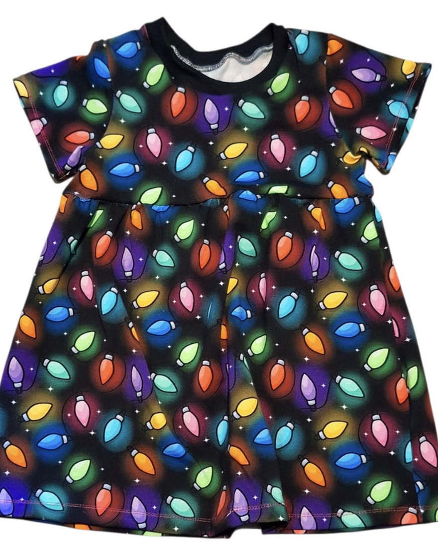 A printed jersey dress laid flat, sewn from a customer’s own design