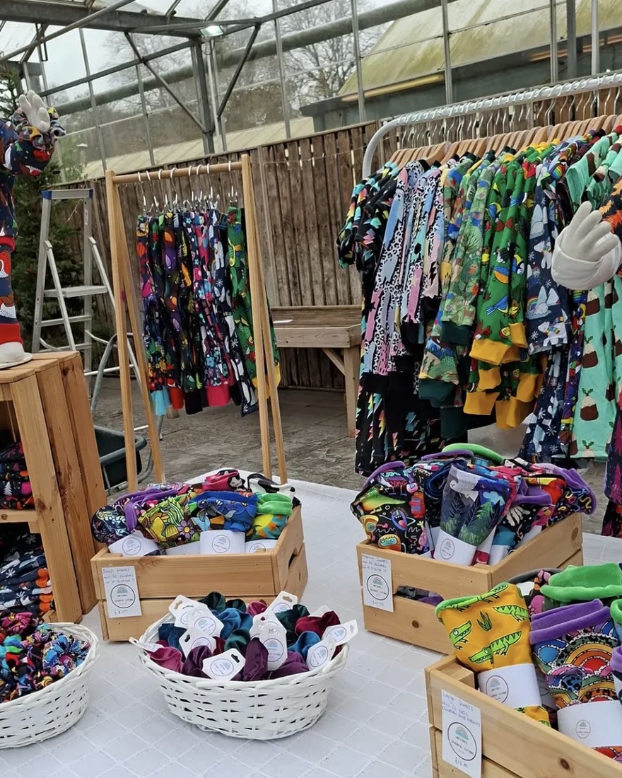 Finished garments on the rails of a brand’s own market stall